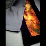 Discharged black velvet scarf with gold, brown, rust, and orange hues lined with rich black polyester